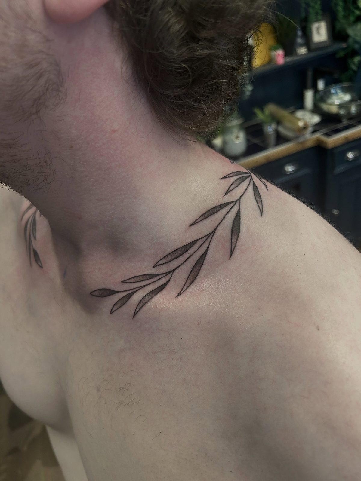 Iron Sky fine line botanical neck tattoo