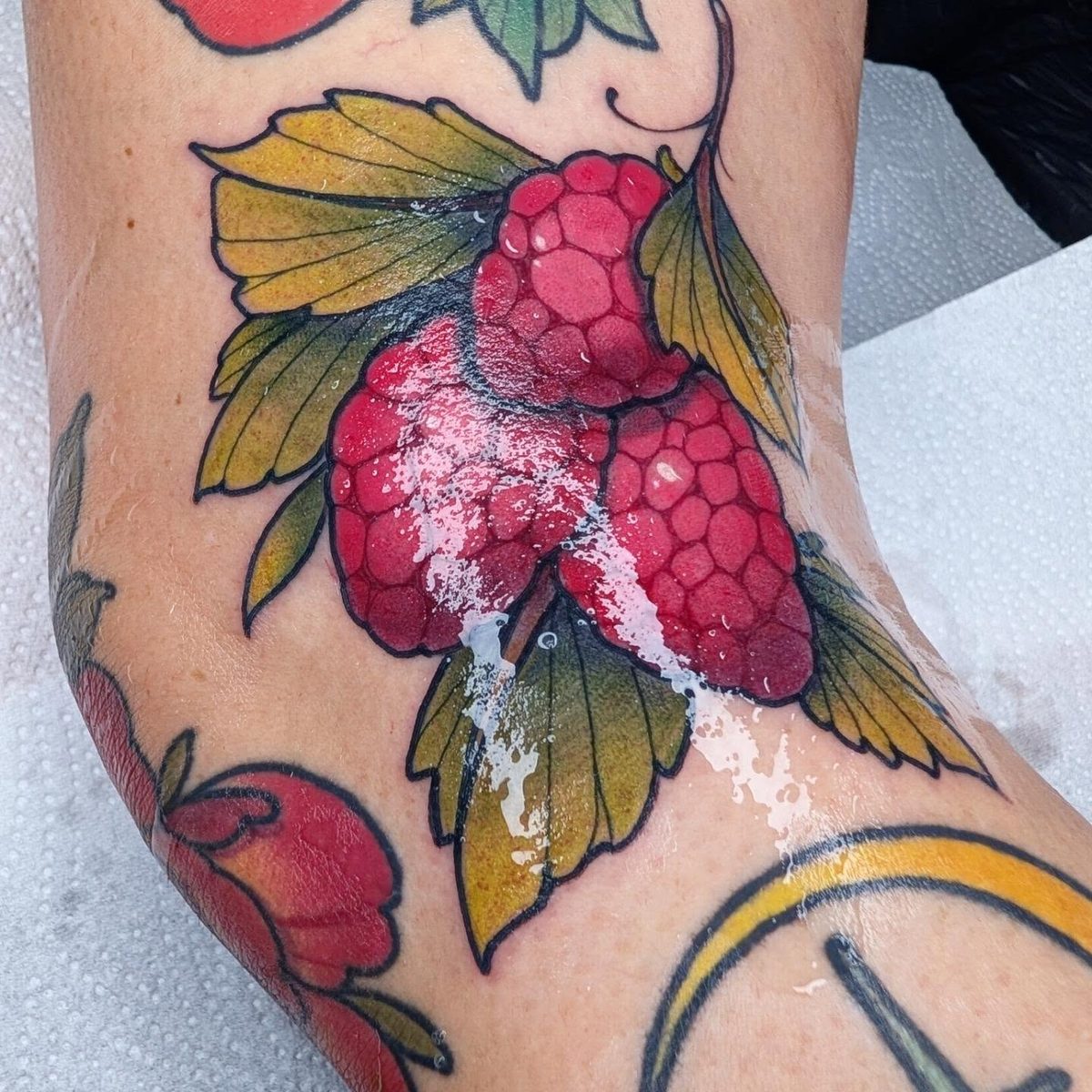 Iron Sky colour raspberry and floral tattoo