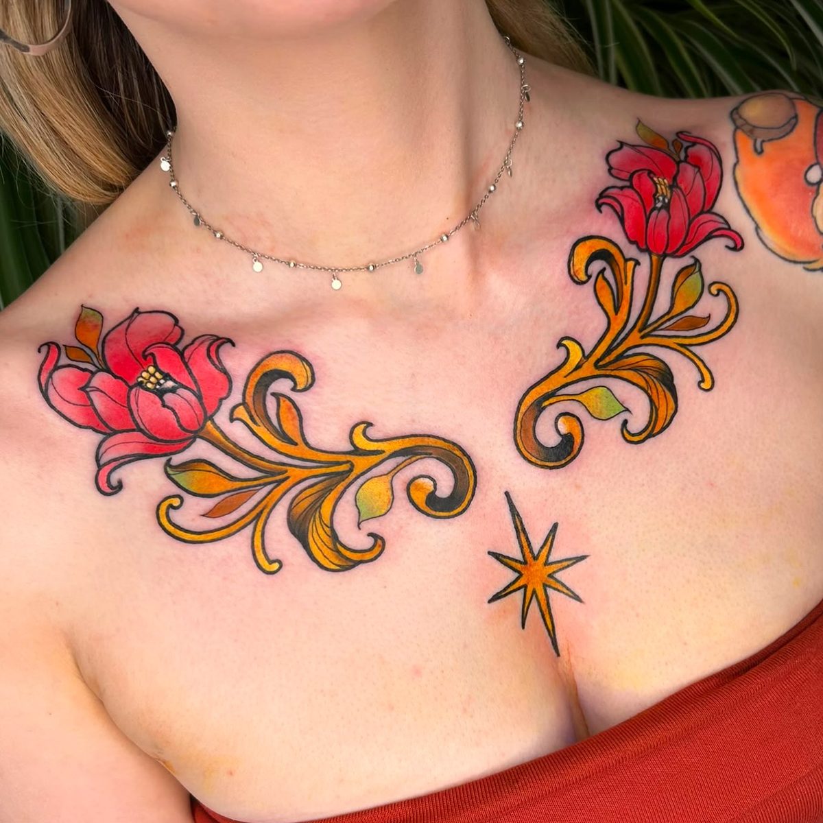 Iron Sky floral chest tattoo with gold filigree